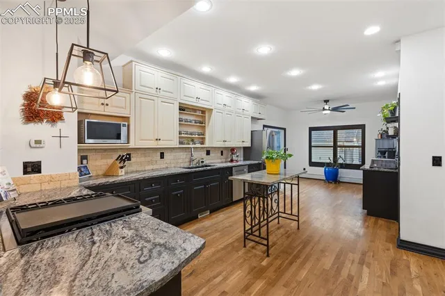 a kitchen with stainless steel appliances granite countertop a stove and a refrigerator