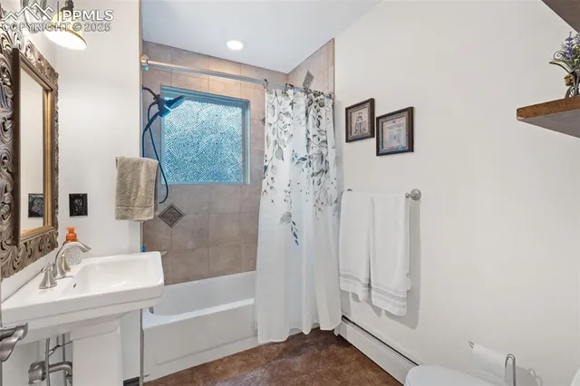a bathroom with a shower sink and mirror