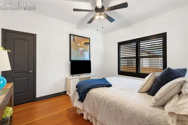 a bedroom with a bed and a flat tv screen