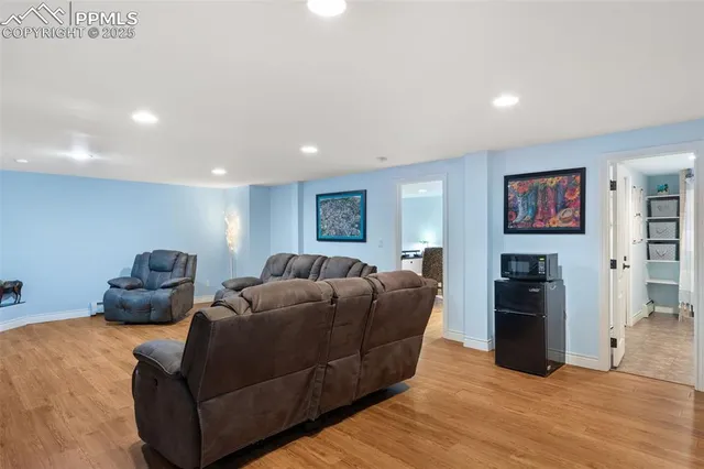 a living room with furniture and a wooden floor
