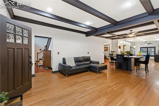 a living room with lots of furniture and wooden floors