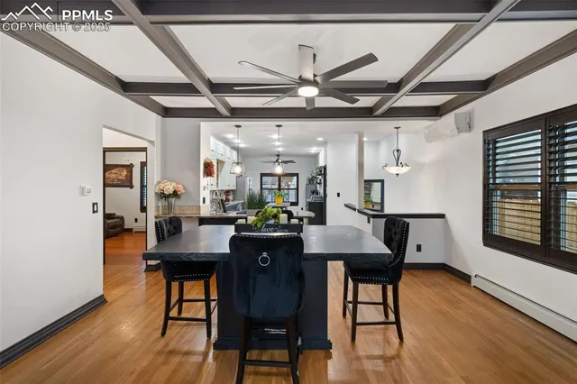 a view of a dining room with furniture window and wooden floor