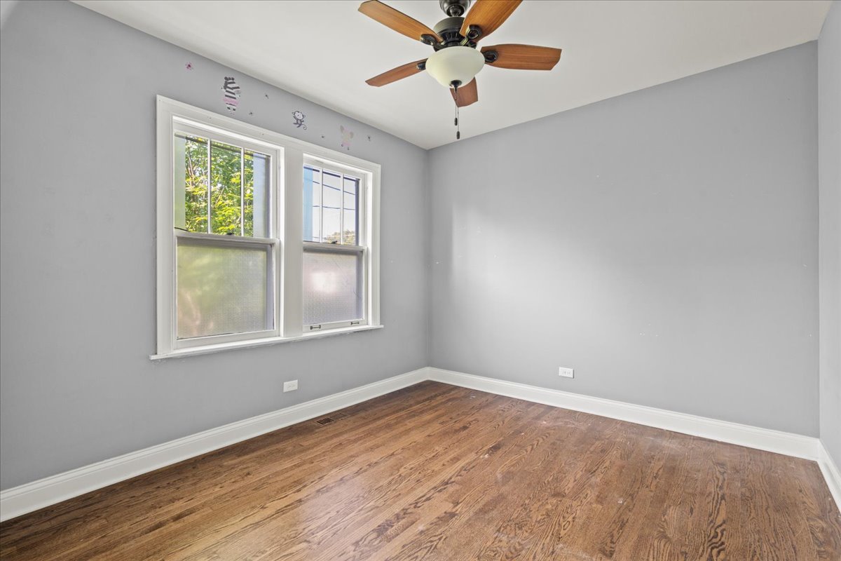 3111 Ruby Street Franklin Park, IL 60131 - Photo 11 of 27 wooden floor in an empty room with a window