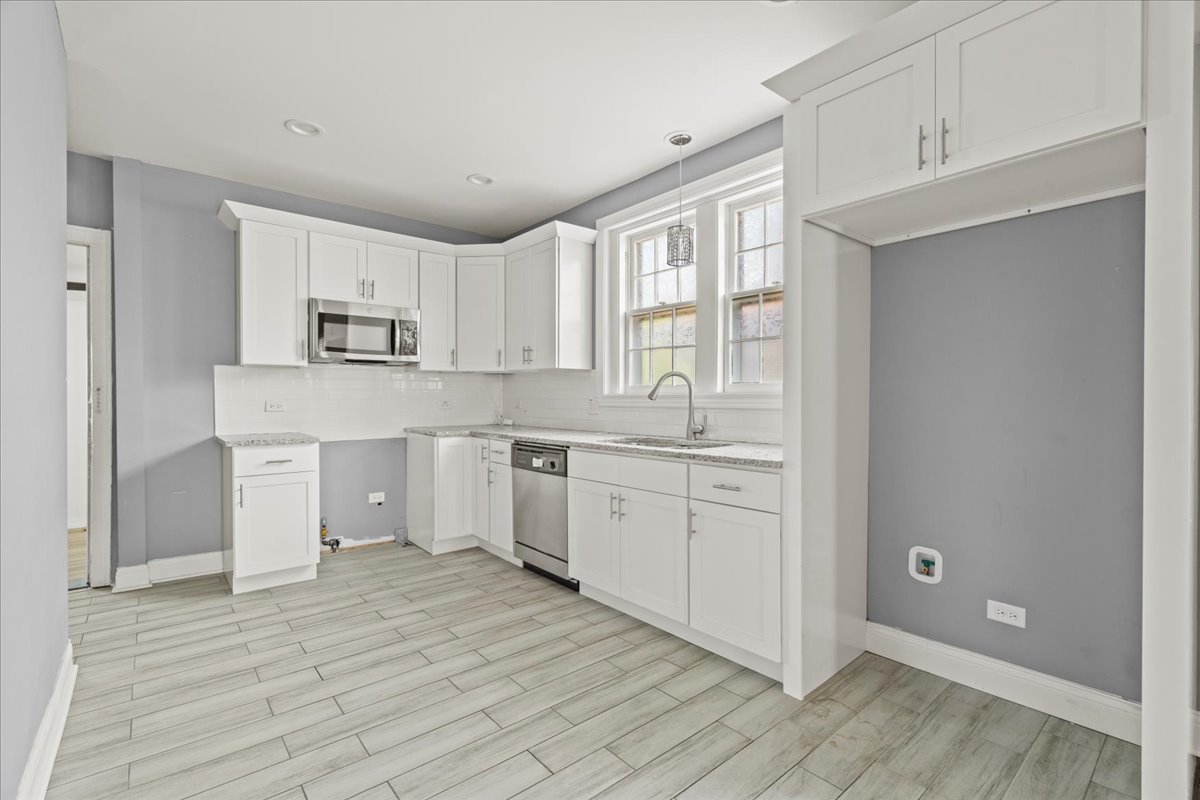 3111 Ruby Street Franklin Park, IL 60131 - Photo 13 of 27 a large white kitchen with white cabinets