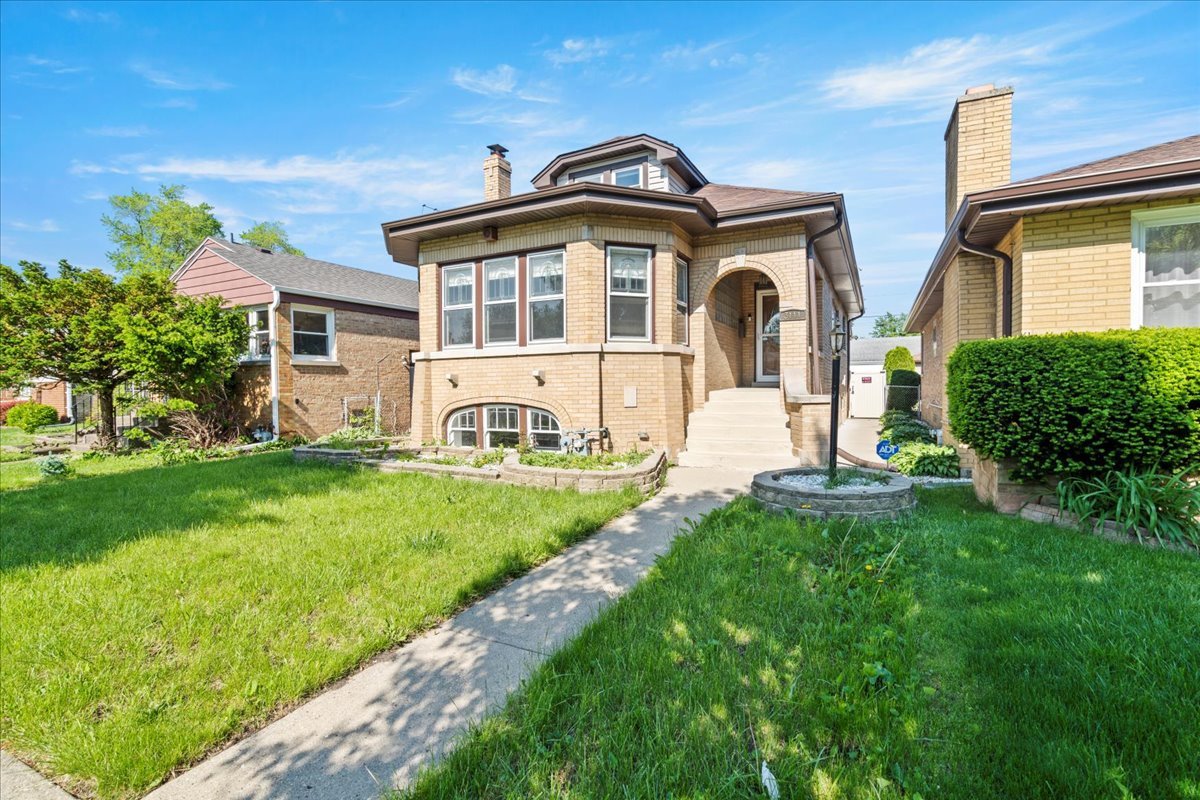 3111 Ruby Street Franklin Park, IL 60131 - Photo 2 of 27 a front view of a house with a yard