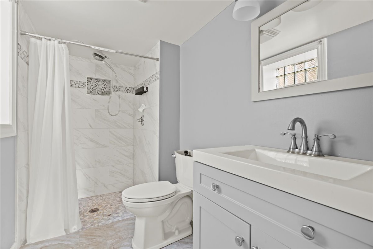 3111 Ruby Street Franklin Park, IL 60131 - Photo 21 of 27 a bathroom with a sink toilet vanity and shower