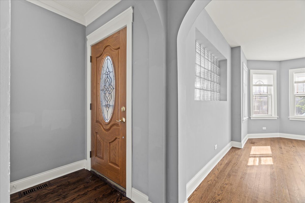 3111 Ruby Street Franklin Park, IL 60131 - Photo 4 of 27 a view of a hallway with wooden floor and a window