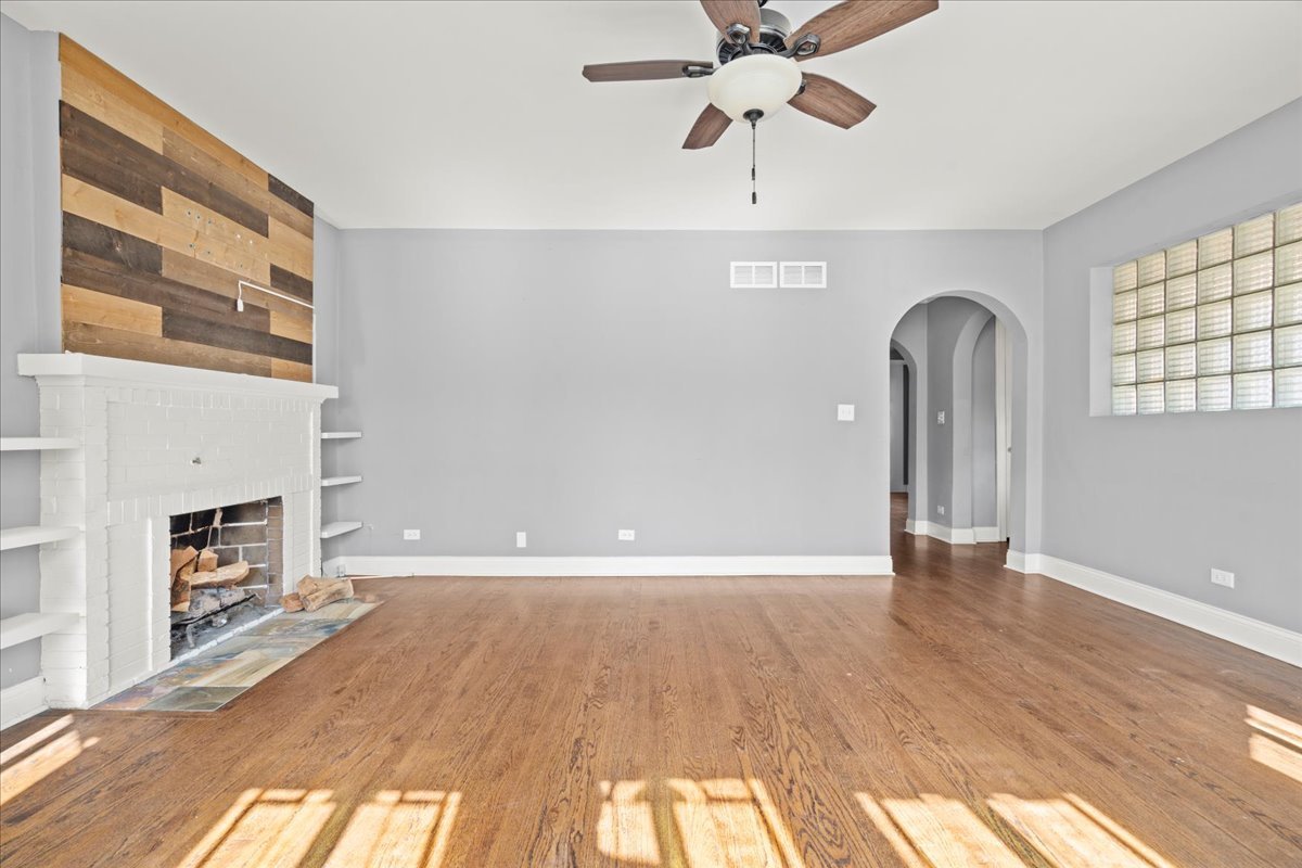 3111 Ruby Street Franklin Park, IL 60131 - Photo 6 of 27 a view of an empty room with a fireplace and a window
