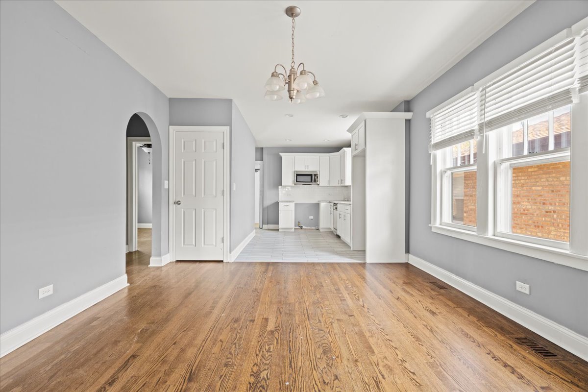 3111 Ruby Street Franklin Park, IL 60131 - Photo 7 of 27 a view of an empty room with a window and wooden floor