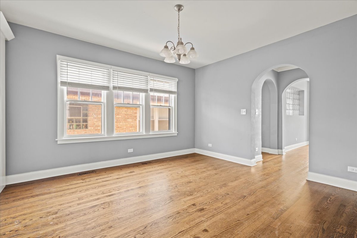 3111 Ruby Street Franklin Park, IL 60131 - Photo 8 of 27 a view of an empty room with wooden floor and a window