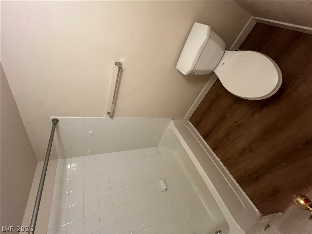 7255 West Sunset Road, Unit 2057 Las Vegas, NV 89113 - Photo 4 of 12 Functional bathroom featuring a shower-tub combination and convenient commode.