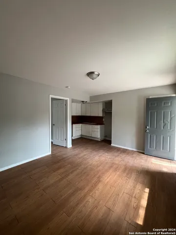 a view of an empty room with a fireplace