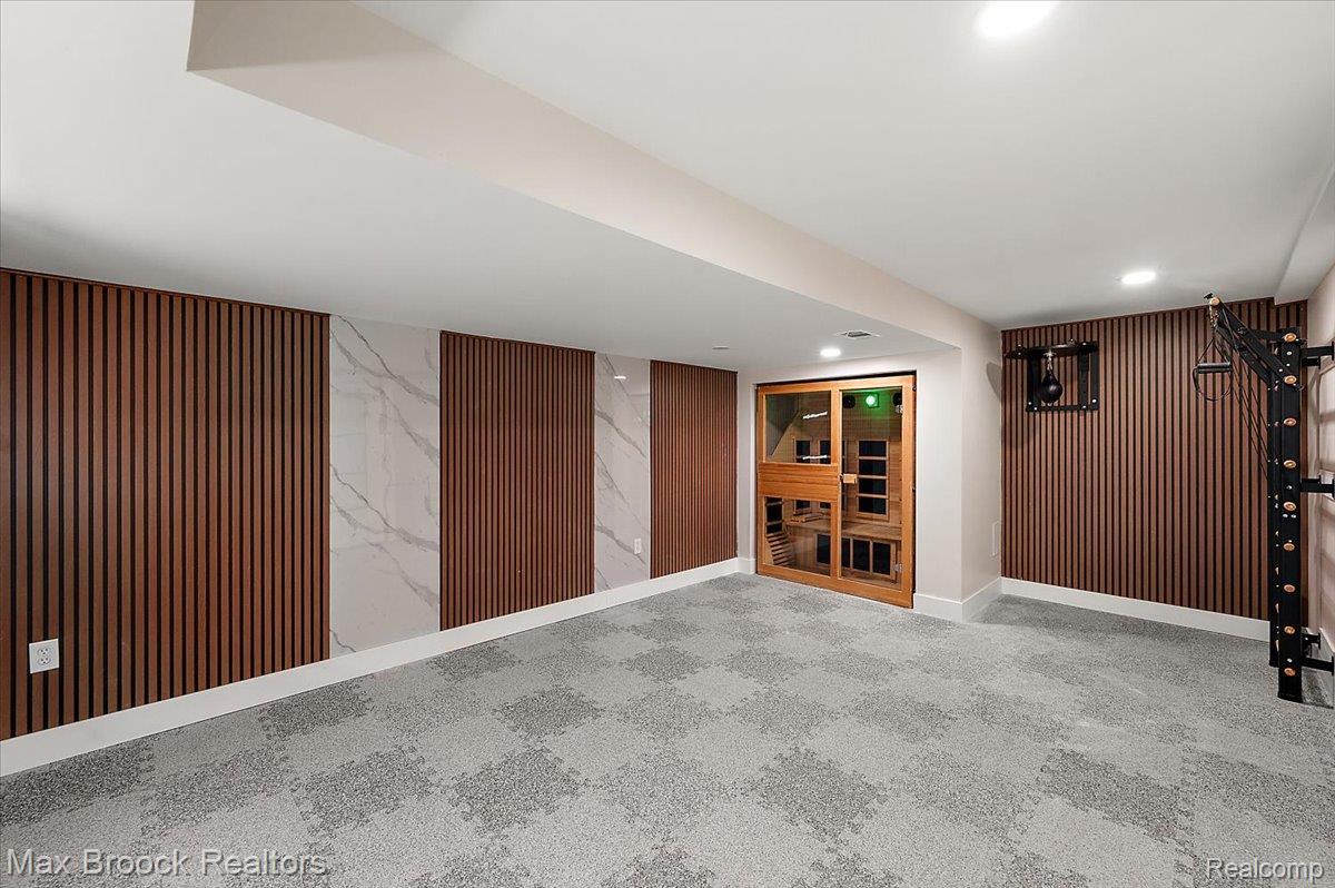 4597 Clarkston Road Clarkston, MI 48348 - Photo 49 of 74 Custom wall treatments featuring wood-tone paneling and marble-look accents