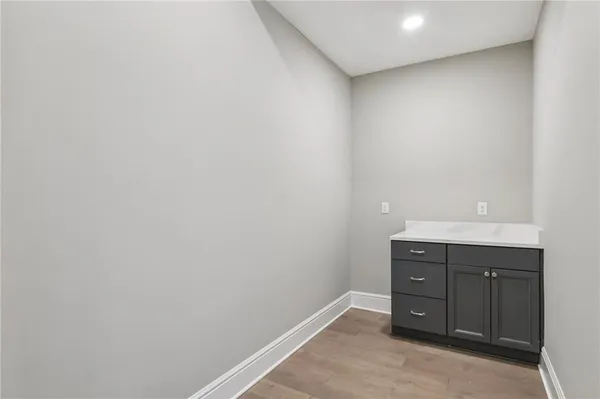 a spacious bedroom with a bed and a flat screen tv