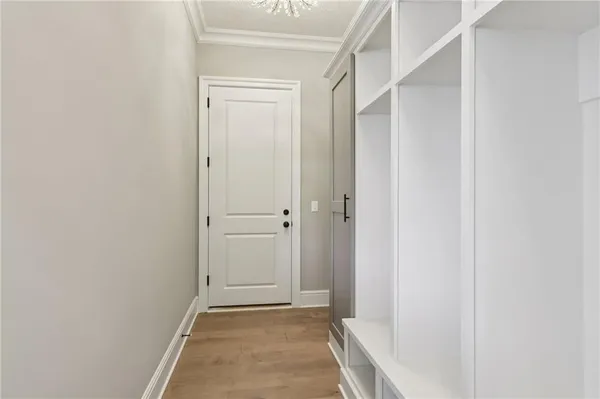 an empty room with wooden floor and window