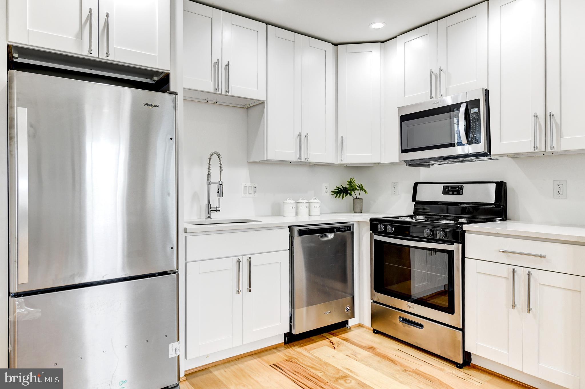 408 Newcomb Street Southeast Washington, DC 20032 - Photo 2 of 8 a kitchen with stainless steel appliances a refrigerator sink and microwave