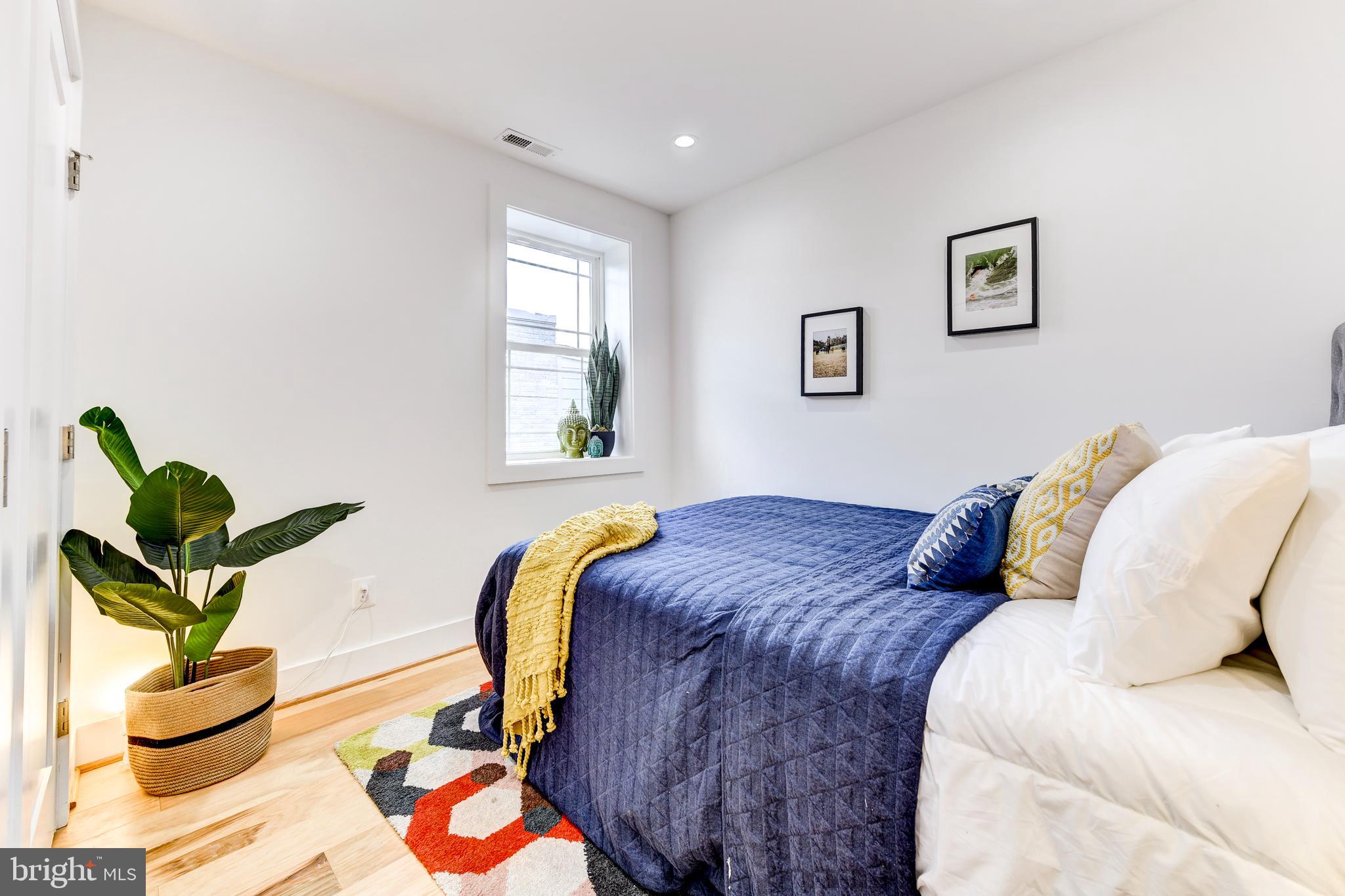 408 Newcomb Street Southeast Washington, DC 20032 - Photo 5 of 8 a bedroom with a bed and window