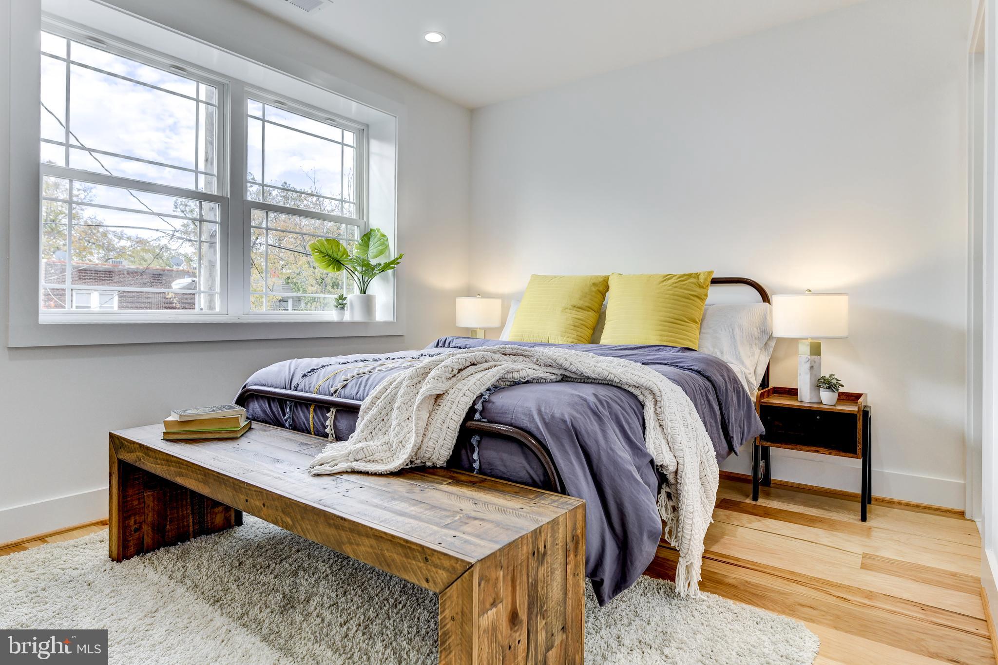 408 Newcomb Street Southeast Washington, DC 20032 - Photo 6 of 8 a bedroom with a bed and a table