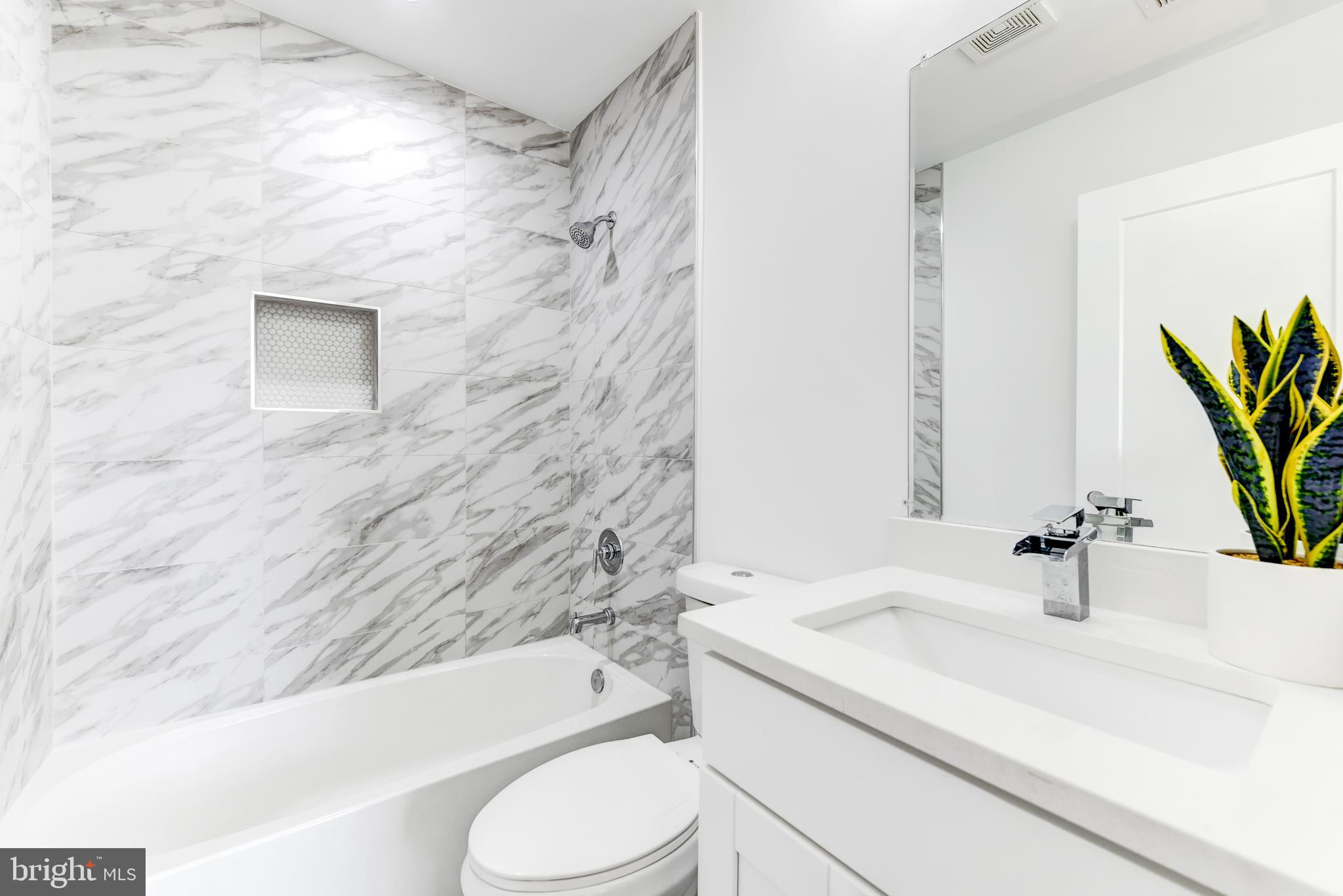 408 Newcomb Street Southeast Washington, DC 20032 - Photo 7 of 8 a bathroom with a sink a toilet and bathtub