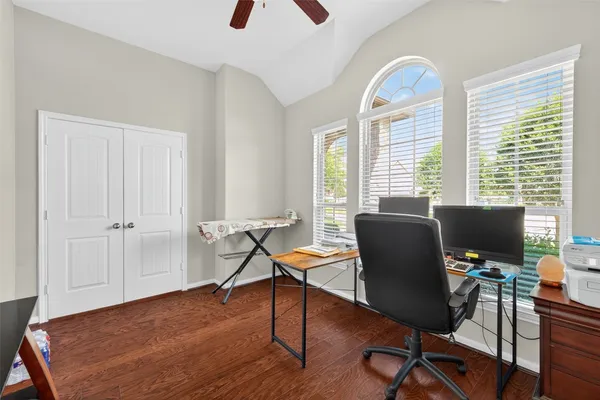 a view of a workspace with furniture and a window