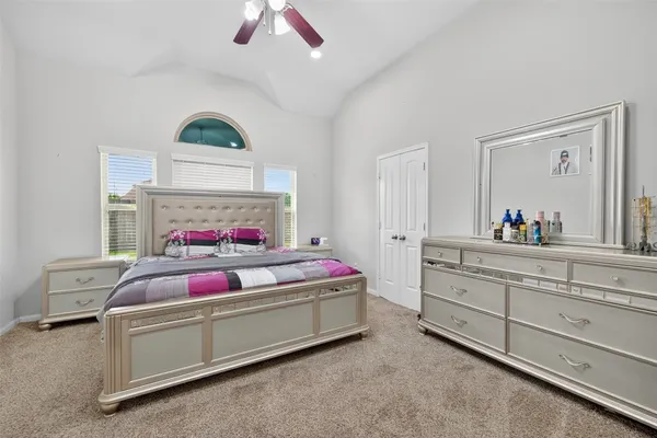 a bedroom with a bed and a mirror