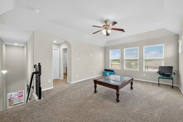 a living room with furniture gym equipment and a window