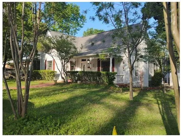 a view of backyard of house with green space