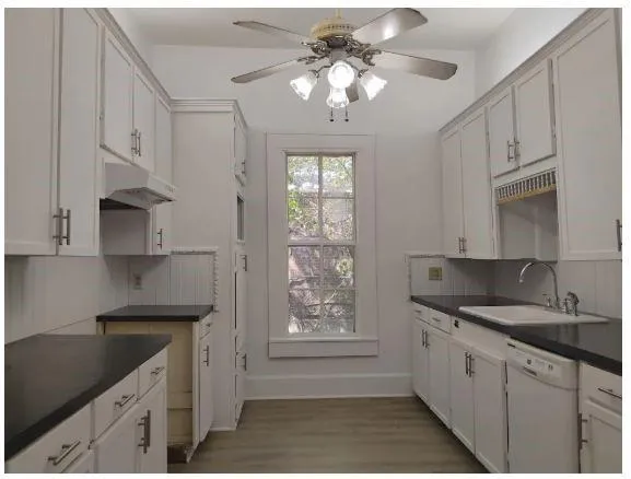 a kitchen with stainless steel appliances granite countertop a sink stove and cabinets