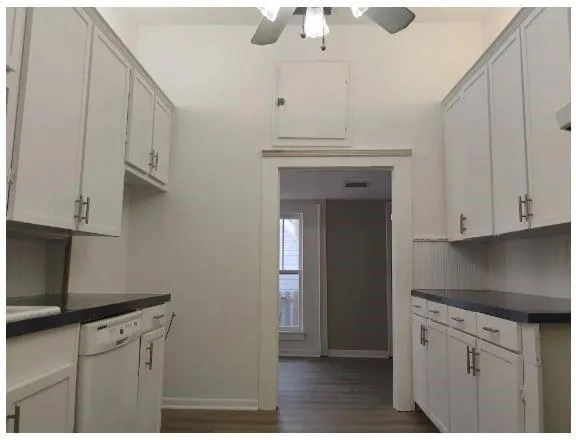 a kitchen with cabinets stainless steel appliances and a counter space