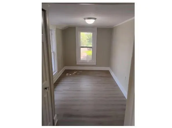 a view of a hallway with wooden floor