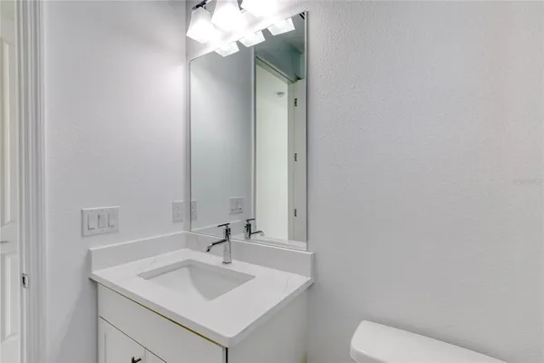 a view of kitchen with center island stainless steel appliances and refrigerator