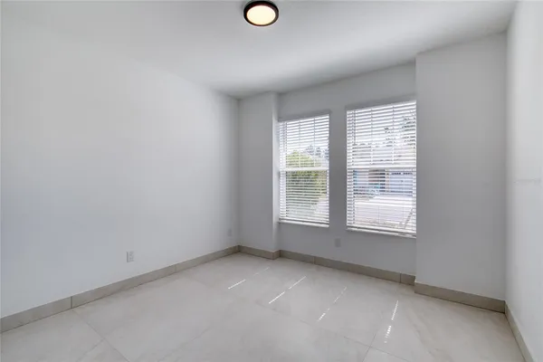 a kitchen with stainless steel appliances kitchen island granite countertop a refrigerator oven a sink a stove with white cabinets