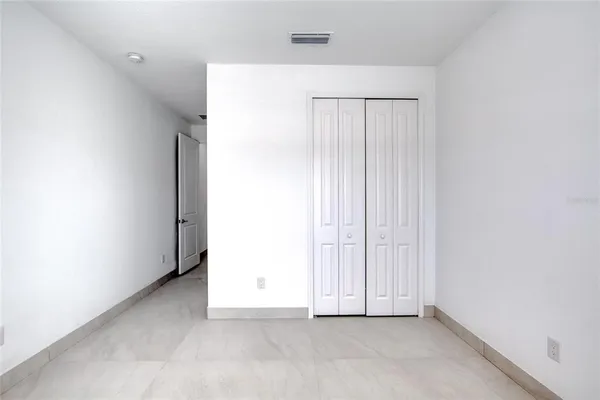 a kitchen with kitchen island stainless steel appliances a sink a stove a microwave a center island and cabinets