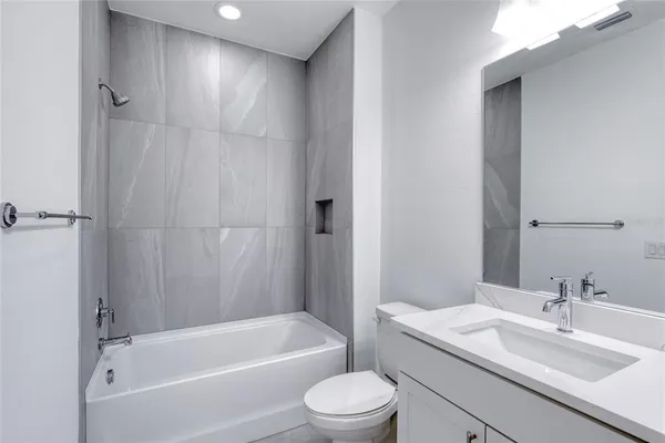 a large white kitchen with sink and windows