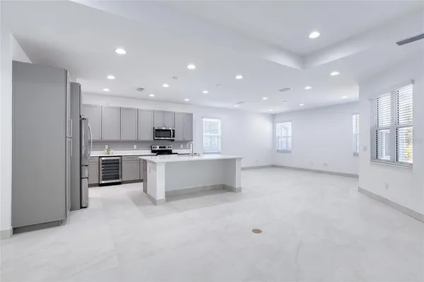 an empty room with a window and a ceiling fan