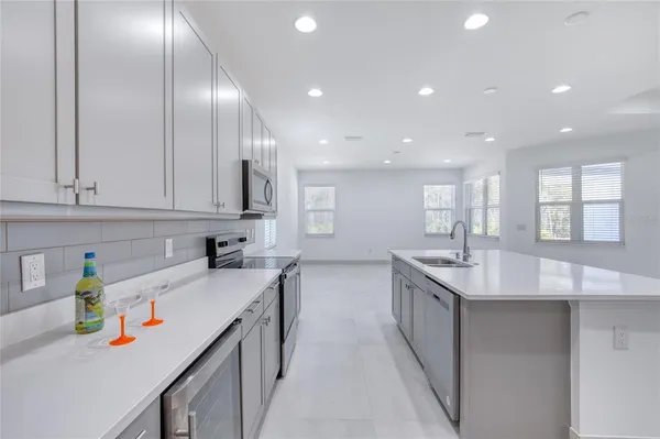 a front view of a house with a yard covered with snow