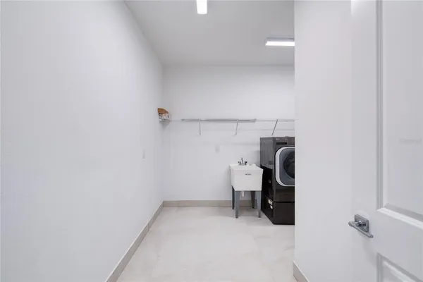 a street sign on a sidewalk next to a road