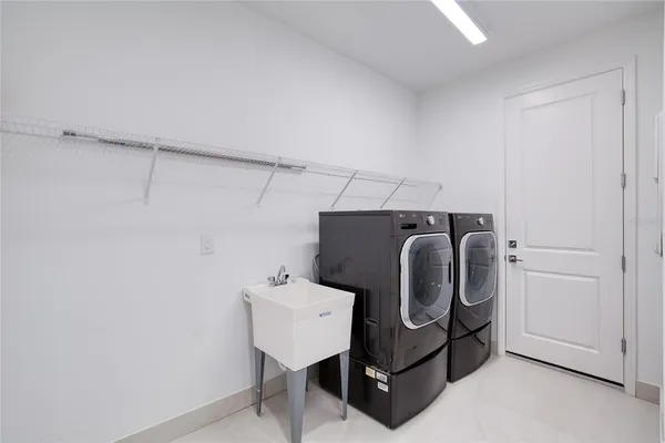 a view of a backyard with a table and chairs under an umbrella