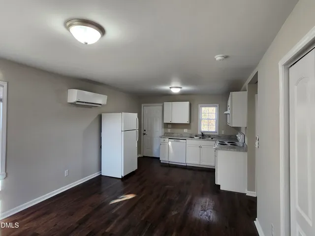 a kitchen with a refrigerator and a stove top oven