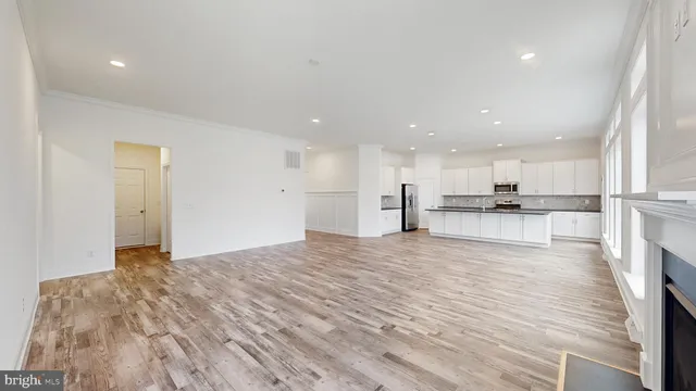a view of kitchen with kitchen island and wooden floor