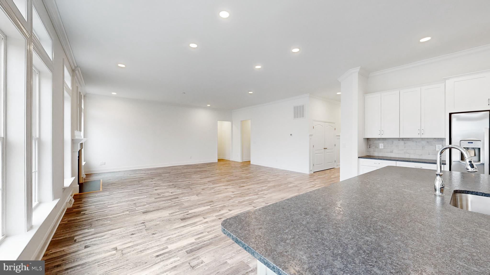 20727 Wilson Road Georgetown, DE 19947 - Photo 18 of 40 a view of an empty room with wooden floor and a window