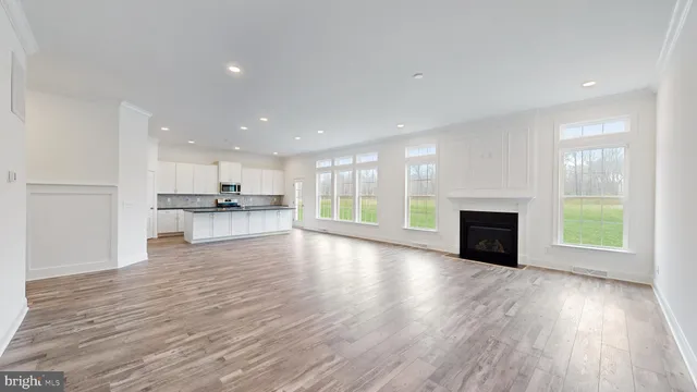 a view of kitchen with stove and wooden floor