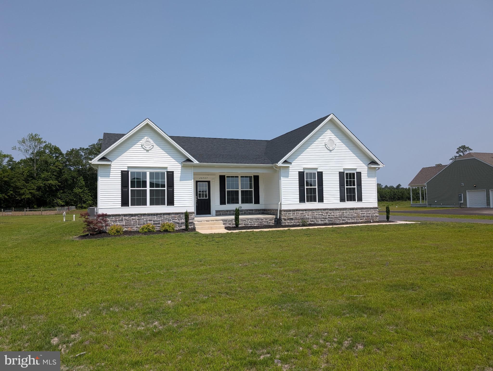 20727 Wilson Road Georgetown, DE 19947 - Photo 3 of 40 a front view of a house with a garden