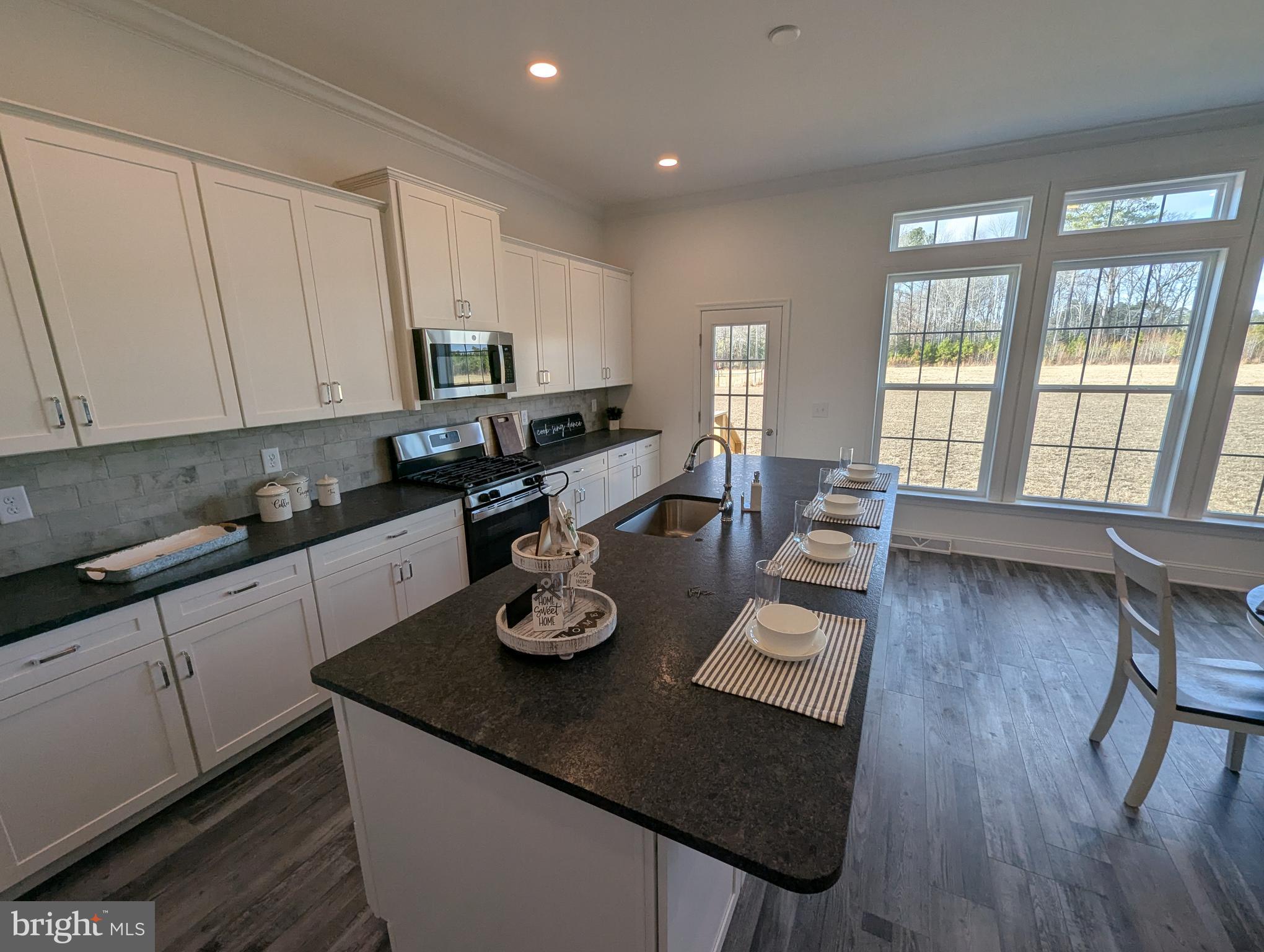 20727 Wilson Road Georgetown, DE 19947 - Photo 5 of 40 a kitchen with a dining table chairs and wooden floor