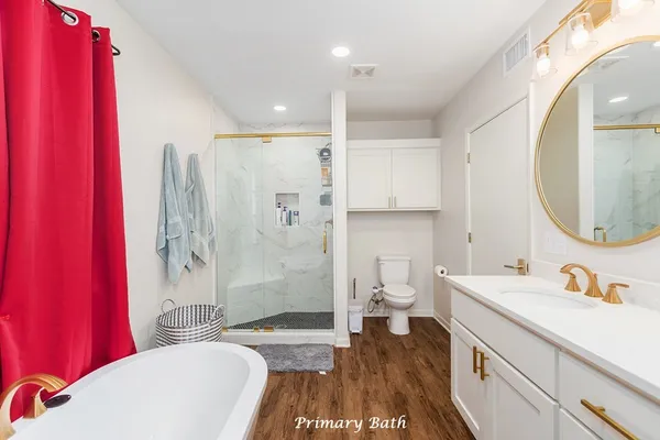 a bathroom with a sink a toilet and a large mirror