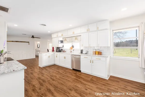 a kitchen with white cabinets and white appliances