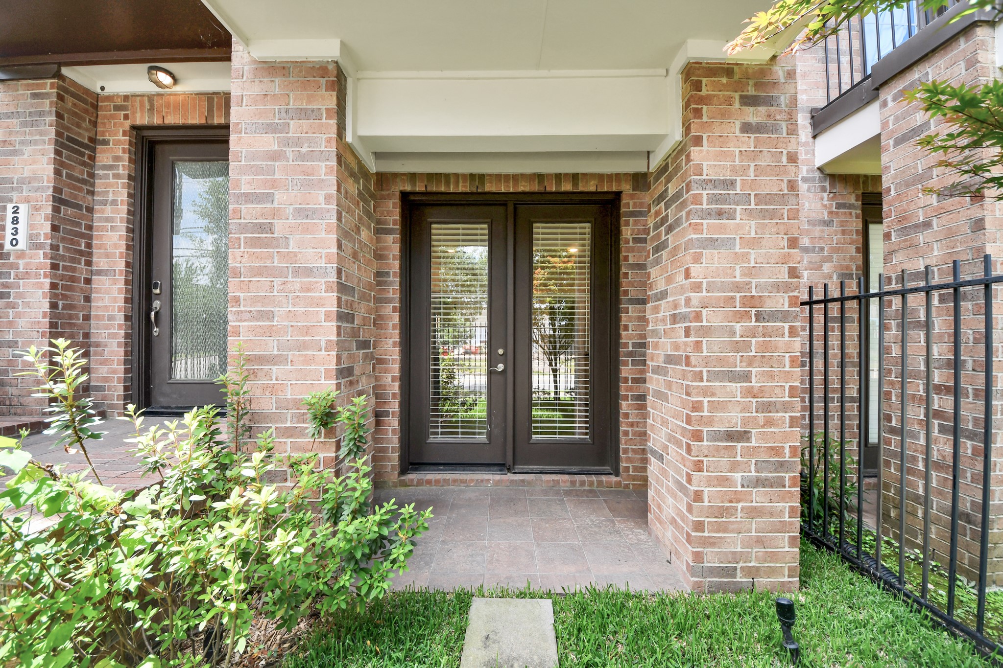 2830 Polk Street Houston, TX 77003 - Photo 6 of 21 French doors from the first-floor flex room open directly to the covered patio and backyard area, creating an easy indoor-outdoor connection. It’s the perfect spot for morning coffee, evening unwinding, or a quiet escape tucked away from the city buzz.