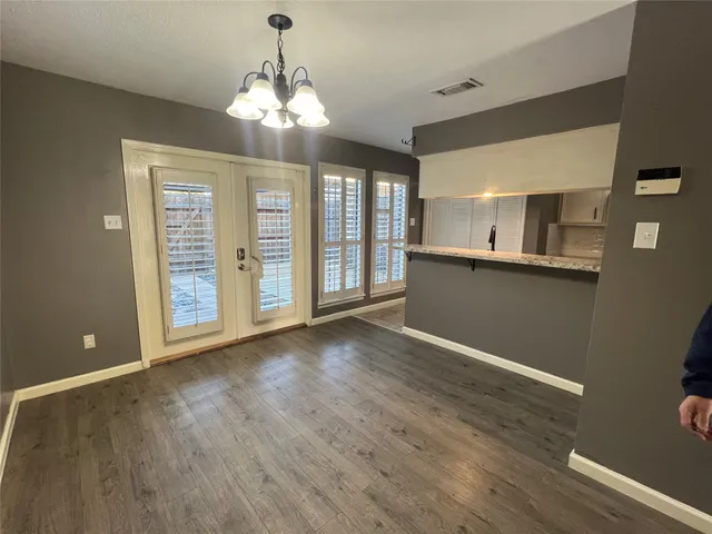 a view of a room with wooden floor and windows