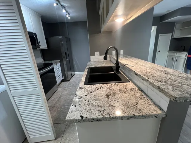 a kitchen with a sink and a stove