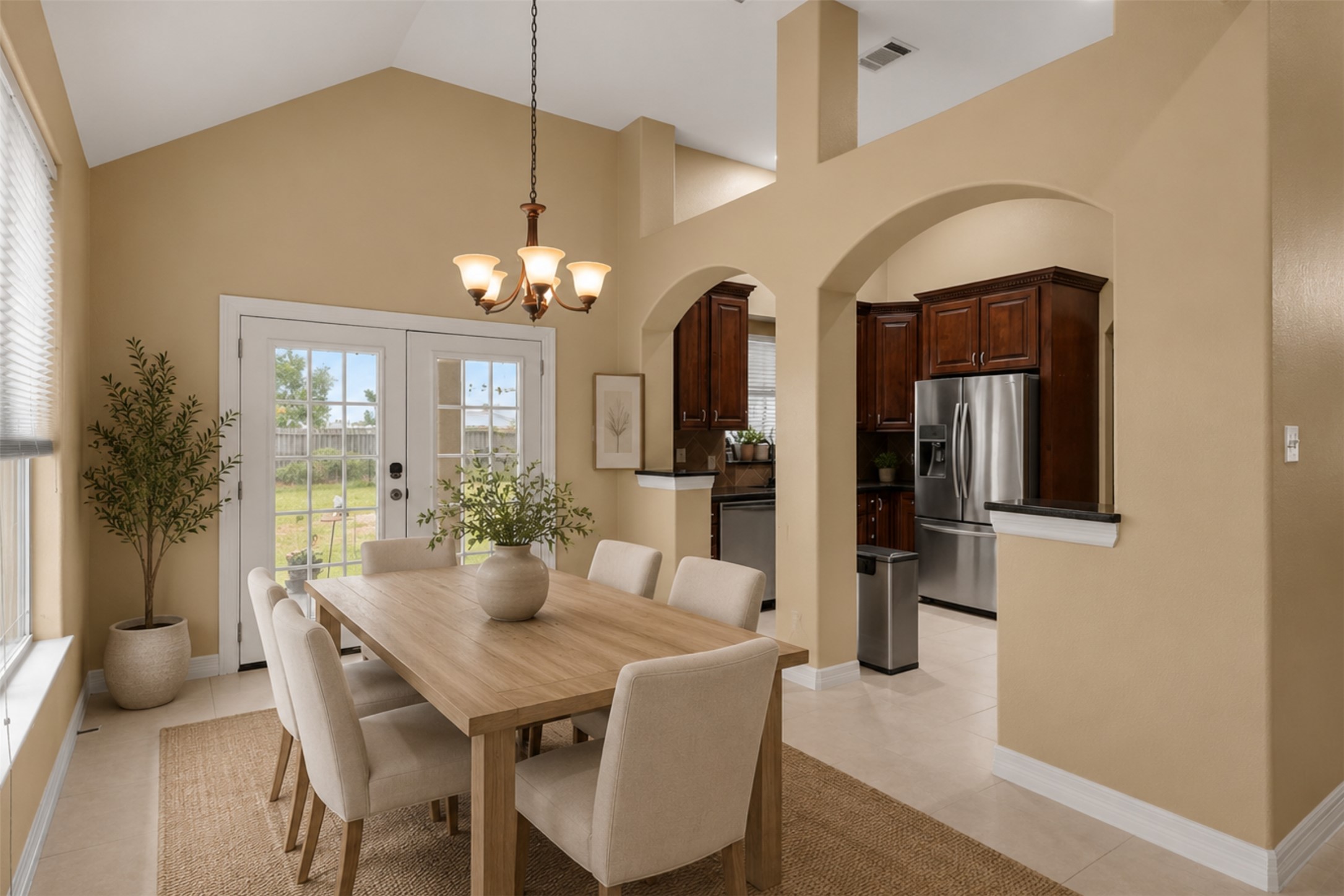 437 Balch Road Elgin, TX 78621 - Photo 6 of 37 *Virtually Staged* French doors open to the yard, framing a sun-filled dining area with soaring vaulted ceilings.